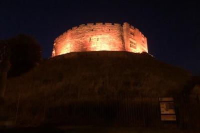 Tamworth Castle lit up in orange